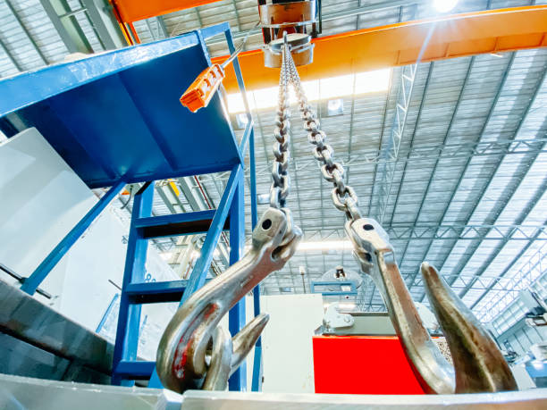overhead crane and machine inside factory building, industrial background. - pulley hook crane construction imagens e fotografias de stock