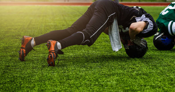 istock Football players stretching before a game 1273593011