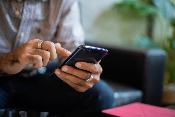 istock Asian business men using smart phone on the coffee shop 1273598731