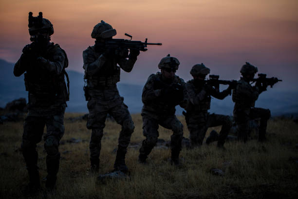 istock Military silhouettes fighting scene on war with twilight background 1273601363