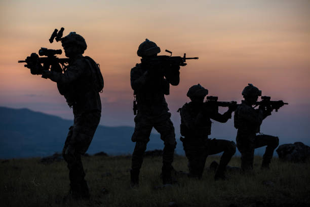 Military silhouettes fighting scene on war with twilight background