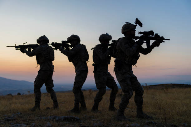 istock Military silhouettes fighting scene on war with twilight background 1273601378