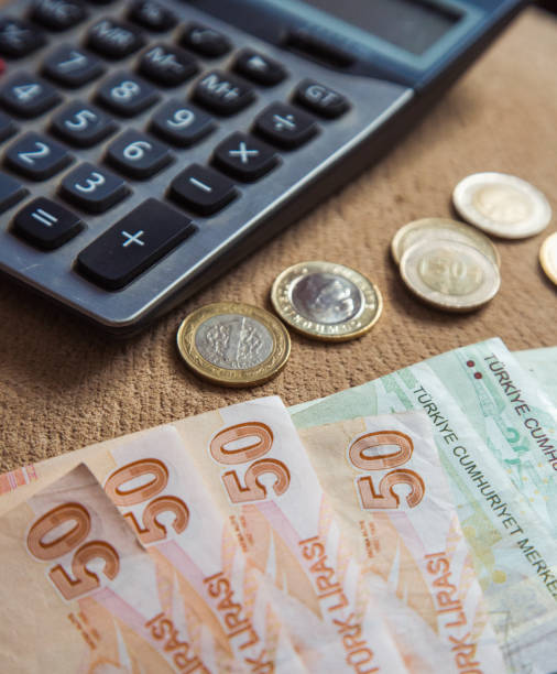 istock Close up calculator money cash coins 1273605848