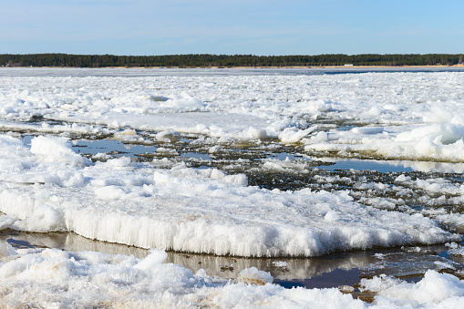 Ice drift on a wide river on a Sunny spring day