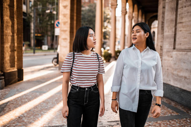 istock Two friends having a walk in the city 1273621866