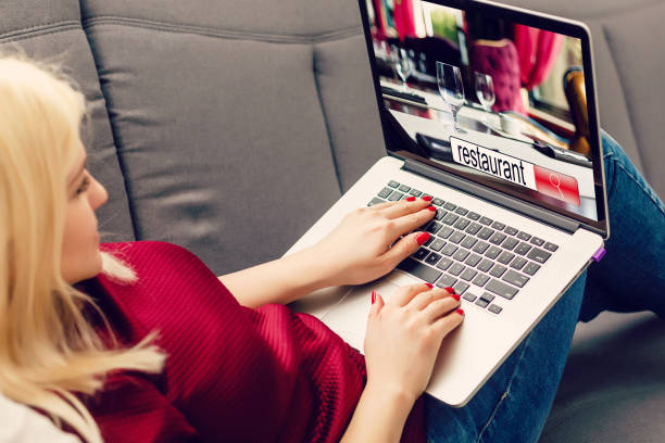 istock Woman hand typing labtop computer with restaurant search on screen background, food and drinks, technology and lifestyle concept 1273628873