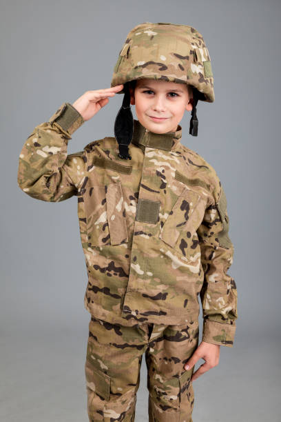 istock Saluting soldier. Young boy dressed like a soldier 1273629199