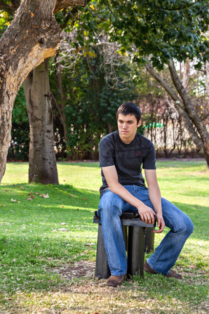 istock teenager with pimples resting in a park 1273632529