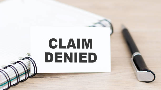 istock a card with text Claim Denied on the table near the notebook 1273634152