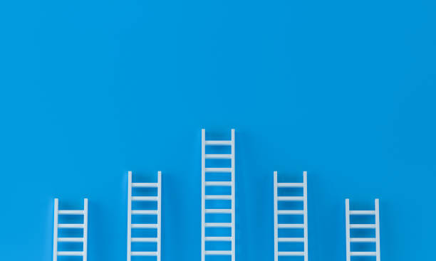 istock Ladder achievement concept on blue wall studio background. leadership, success concept with copy spaces for text. 3d rendering. 1273634737