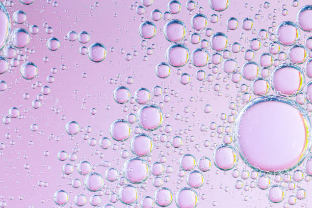 istock Closeup abstract bubbles oil in water with pink shiny background ,macro image ,droplets blurred ,sweet color 1273638134