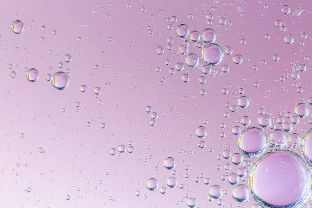 istock Closeup abstract bubbles oil in water with pink shiny background ,macro image ,droplets blurred ,sweet color 1273638740
