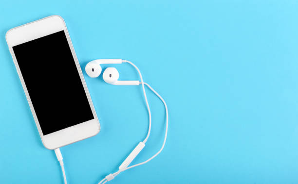 istock smartphone and headphones business concept blue background 1273640648