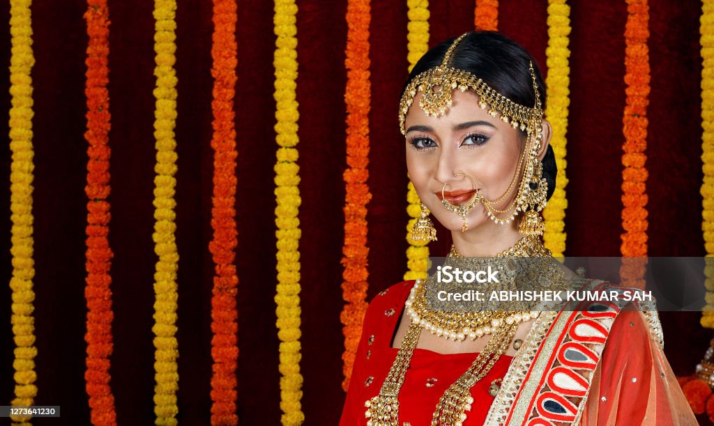 Young woman wearing traditional Indian Dress and celebrating Diwali. Young Indian Female model wearing traditional Indian Dress and celebrating Diwali. She is holding Candles or Diya in Hand. Studio shot with extra copy space. Bride Stock Photo