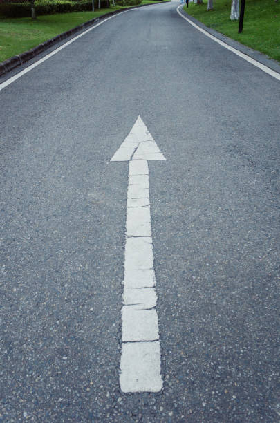 istock Weahtered painted arrow on asphalt street. 1273641263