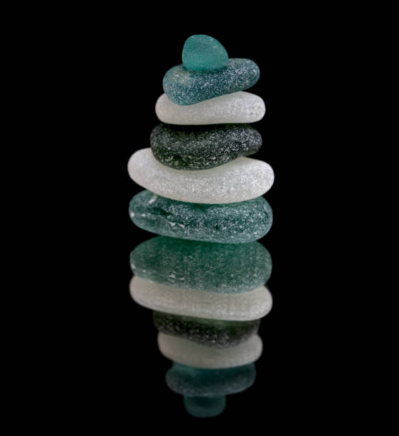 istock small sea glass pyramid isolated on black, reflective surface 1273645105