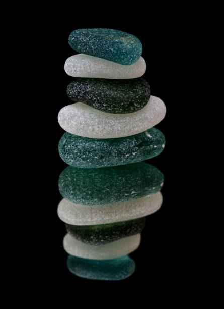 istock small sea glass pyramid isolated on black, reflective surface 1273645112
