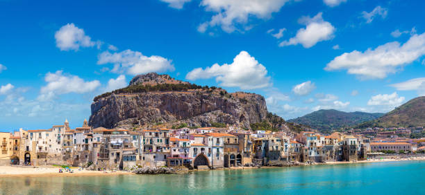 Sandy beach in Cefalu in Sicily Panorama of Harbor and old houses in Cefalu in Sicily, Italy in a beautiful summer day cefalu stock pictures, royalty-free photos & images