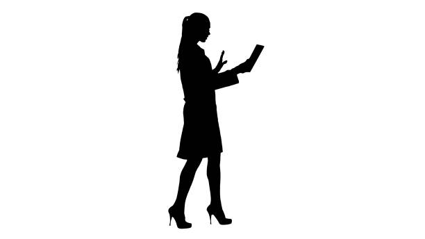 Silhouette Young woman doctor holding tablet in her hands and ma Full length side view. Silhouette Young woman doctor holding tablet in her hands and making video call. Professional shot in 4K resolution. 013. You can use it e.g. in your commercial video, business, presentation, broadcast nurse silhouettes stock illustrations