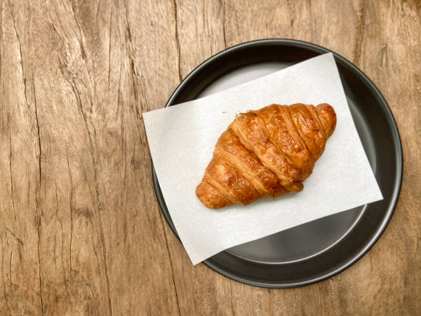 istock Baked croissants bakery for breakfast on brunch on wooden table 1273655243