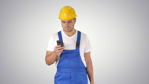 istock Factory worker employee chatting browsing texting on smartphone 1273656924