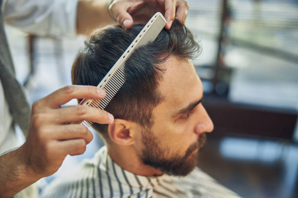 istock Brunette man looking serious at a barbershop appointment 1273656989