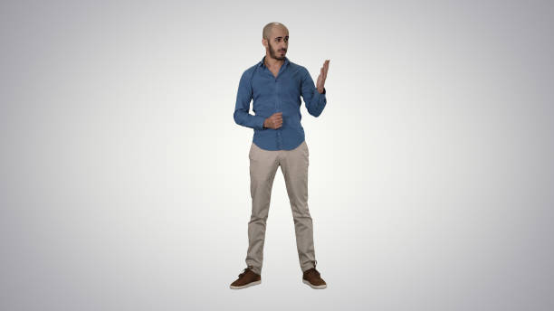 istock Arabic young man in shirt talking presenting something and point 1273656990