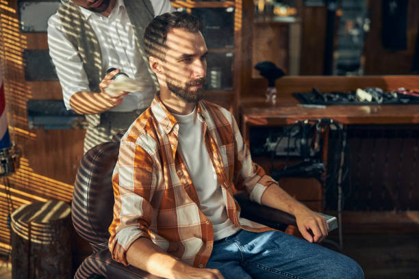 istock Brunette young man getting a fresh shave a barbershop 1273656997
