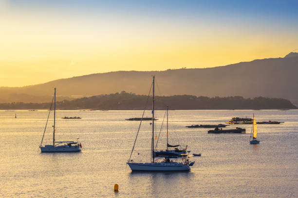 istock Sailboats and rafts at sunset 1273658289