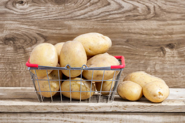 istock raw potatoes on wooden table 1273658327