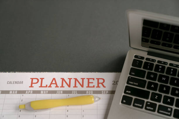 istock Calendar planner with computer laptop on table. Planning and organizing activities concept. 1273659128