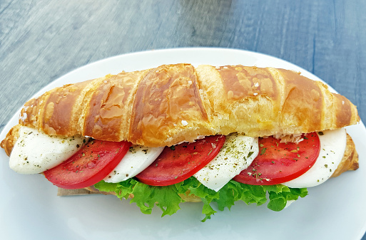 Delicious sandwich stuffed in a fresh baguette, bursting with flavor and wholesome ingredients. Flat lay with copy space