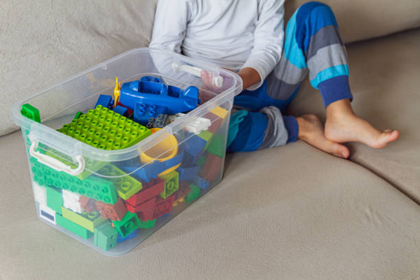 istock Child playing with toy blocks sitting on sofa 1273660306
