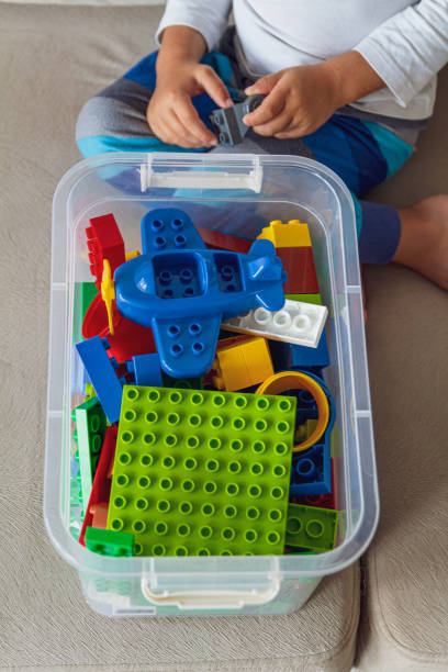 istock Child playing with toy blocks sitting on sofa 1273660328