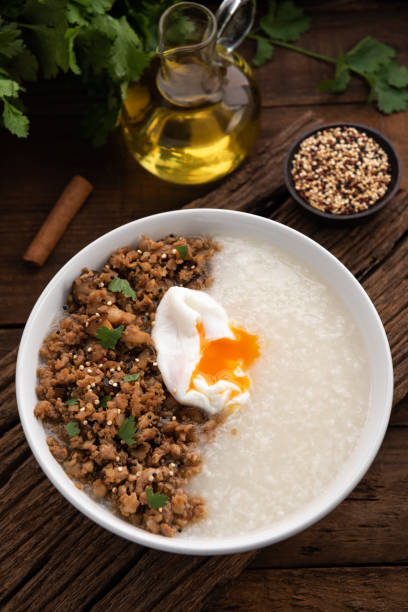 istock congee with pork and egg on wood food background 1273663444