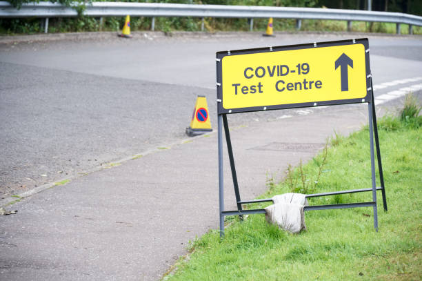istock Covid-19 test centre sign at road with traffic cones 1273663466
