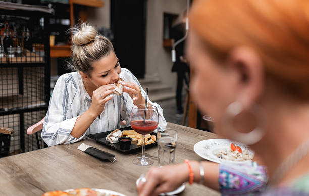istock Mother and daughter having lunch in a cafe 1273663502