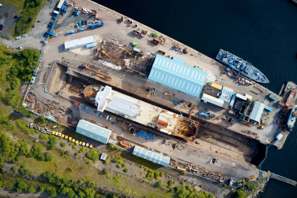 istock Shipbuilding construction ship in dry dock aerial view at shipyard harbour with scaffold 1273663868