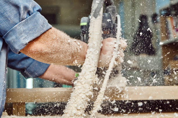 istock Carpenter with hand electric router machine at work. Milling process of acrylic kitchen countertop 1273664456