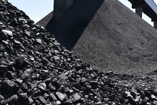 Heaps of industrial coal. Coal mine, coal storage.