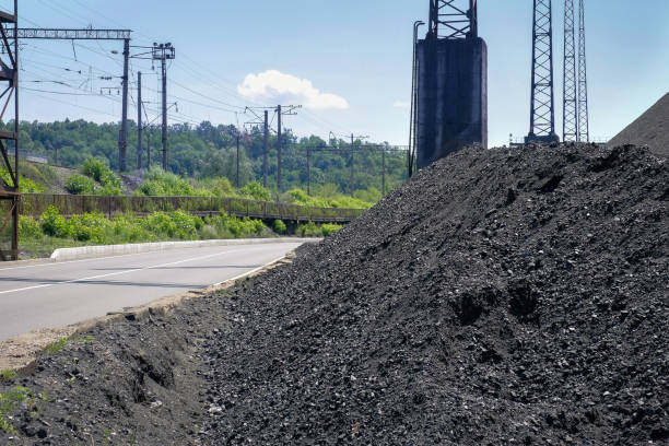 natural heaps of industrial coal. coal mine. production of useful minerals. - cinza imagens e fotografias de stock