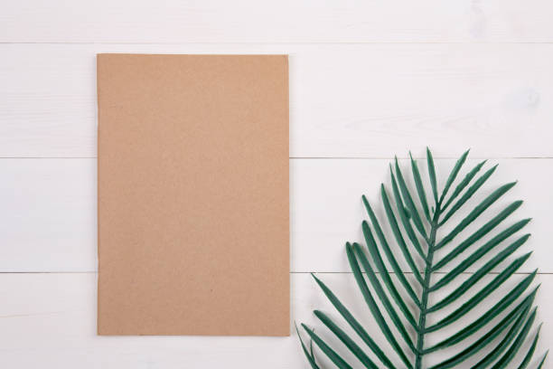 istock Blank cover book copy space with mockup and leaf on wooden table, poster and notebook, postcard decoration your design or branding, simplicity and minimal, nobody, flat lay, top view. 1273665801