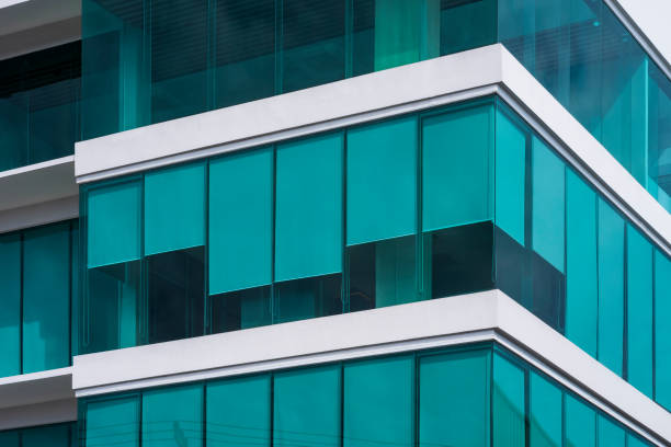 Low angle view of blue roller blinds inside of modern glass office building