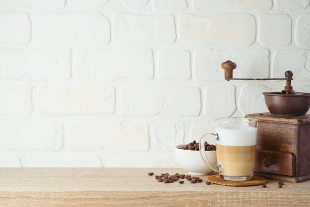 istock Kitchen background with coffee cup and coffee mill grinder on wooden shelf 1273670363