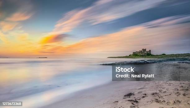 Early Morning Light On The Seashore Near Bamburgh Castle Northumberland Uk Stock Photo - Download Image Now
