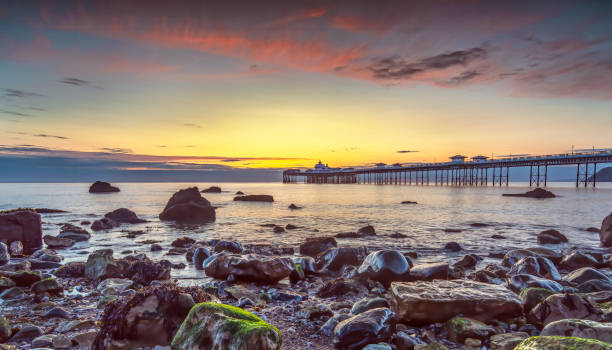 Landscape image of the historic pier in Llandudno at Sunrise