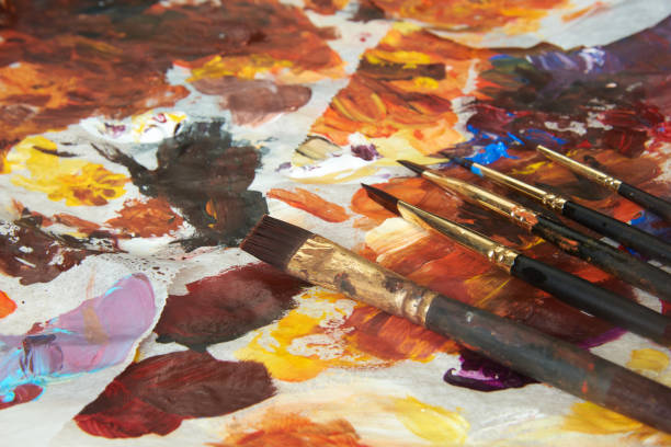istock Paintbrushes and acrylic colors on palette 1273672823