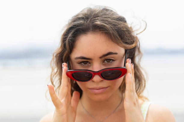 istock Young woman wearing sunglasses looking at camera 1273672951