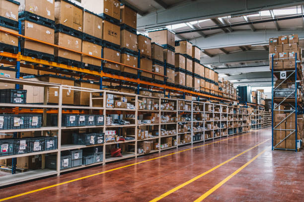 View of empty industrial material warehouse Rows of many shelves with cardboard boxes in storage room of huge distribution warehouse aisle in industrial storage factory background XXXL size warehouse tools stock pictures, royalty-free photos & images