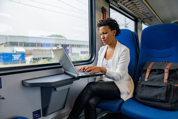 istock Afro-American woman using laptop on public transport 1273675913